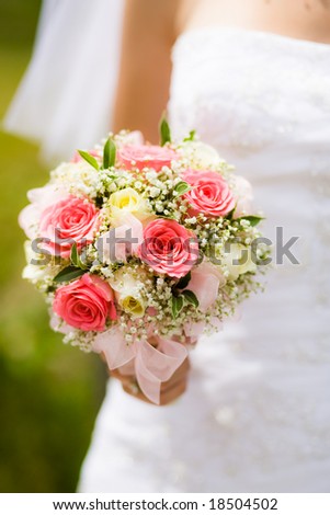 stock photo Wedding bouquet with white and pink roses in bride hand