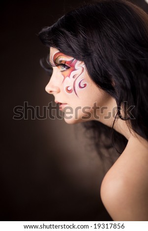 stock photo Face art on beautiful fashion model in half face at brown 