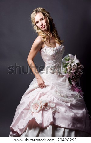 stock photo Beautiful blond bride wearing wedding dress posing on gray 
