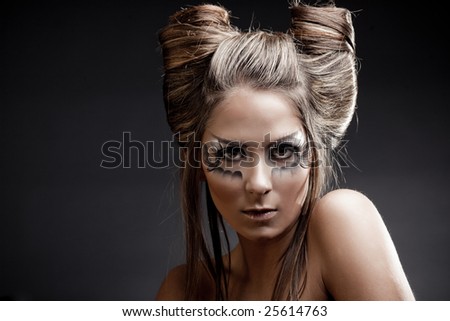 stock photo : Fashion model with halloween makeup and hairstyle on black 