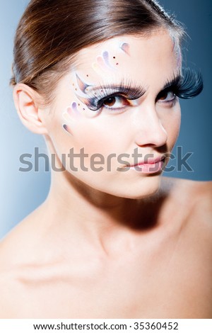 stock photo Fashion makeup with face art and extra long lashes