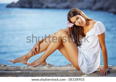 stock photo Portrait of beautiful brunette woman with long legs posing