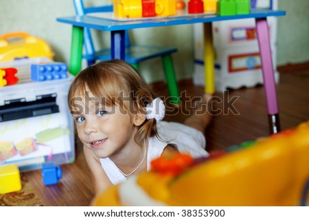 Playful child in her nursery at home