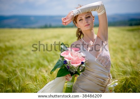 Bride posing in eared field