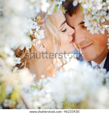 stock photo Kissing wedding couple in spring nature closeup portrait