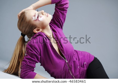 Beautiful fashion girl wearing fashion purple jacket posing in studio