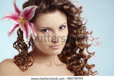 Portrait of very cute young woman with healthy curly hair