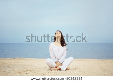 Young woman resting at beach near the sea