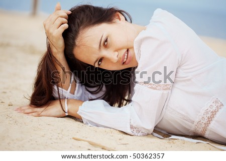 Young woman resting at beach near the sea