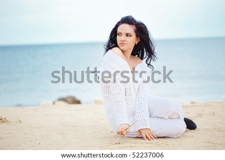 Young girl resting at beach near the sea