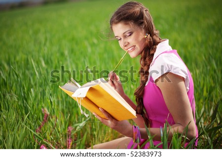 Student girl resting in summer field