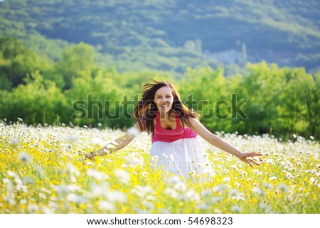 Young beautiful girl resting in flower field