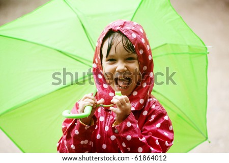 Little child walking in the rain