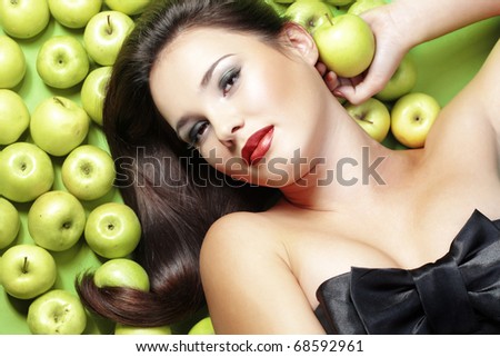 Portrait of young beautiful woman with apples