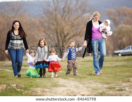 Group of kids with parents walking outdoors