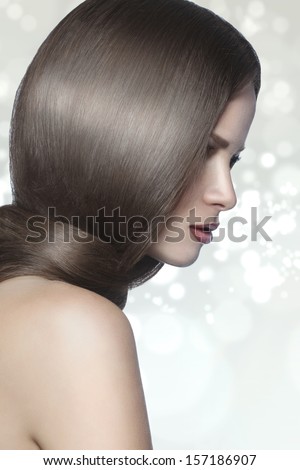 Studio portrait of a model showing her healthy shining hair