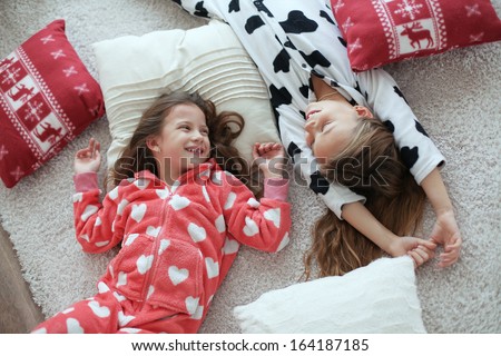 Children in soft warm pajamas playing at home