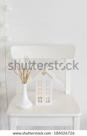 Rustic decor on a white shabby chic chair near the wall