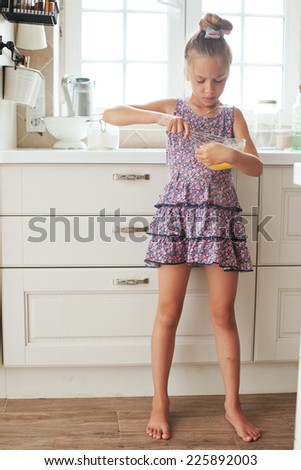 7 years old school girl cooking on the vintage kitchen, casual lifestyle photo series
