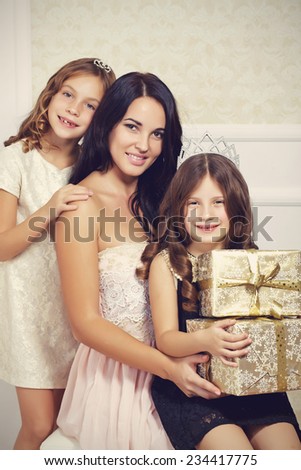 Portrait of luxury family with gold gift boxes