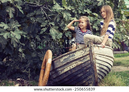 Kids playing inside old boat in summer