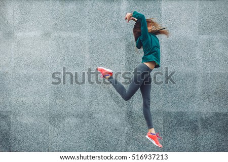 Fitness sport girl in fashion sportswear dancing hip hop in the street, outdoor sports, urban style