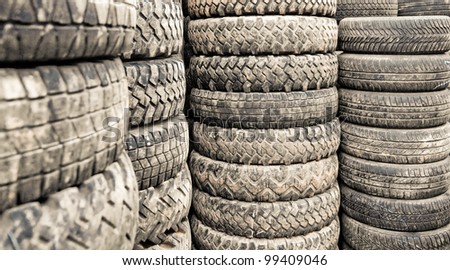 Car tyres stacked in a tyre distribution centre. Selective focus.