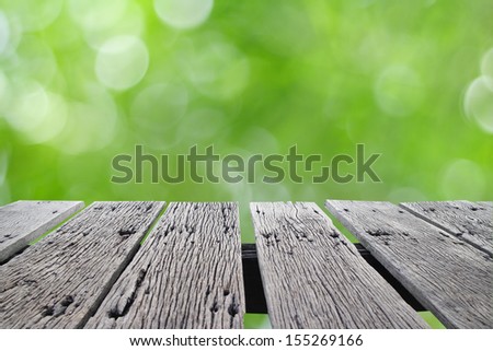 Empty wooden deck table  over bokeh background