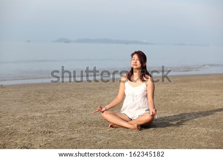 Spa vacation retreat woman relaxing at luxury travel resort. Happy blissful asian young woman in bikini in meditation enjoying summer sun and tanning during holidays .