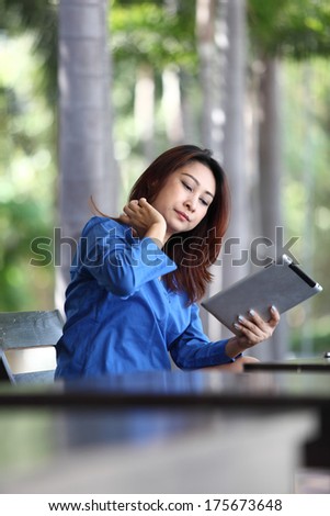 Tablet computer. Woman young smiling mixed race reading relaxed on  tablet