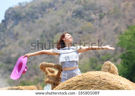 Happy free woman enjoying nature. Freedom and serenity concept with female model in ecstatic enjoyment. Mixed race Asian Caucasian female model in 40 enjoying outdoor style, north in Thailand