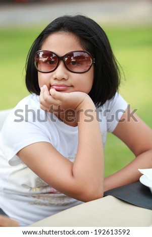 Summer girl portrait. Asian woman smiling happy on sunny summer or spring day outside in park by her house. Pretty mixed race Caucasian / Chinese Asian young woman outdoors.