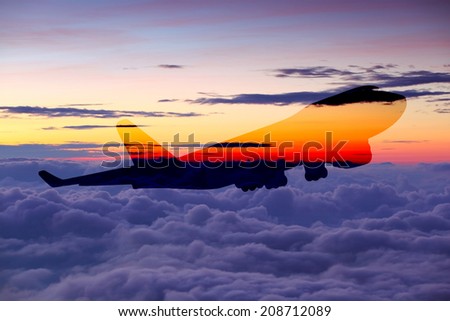 perspective view of jet airliner in flight on sky over cloud at sunrise time it\'s very beautiful , use for air transport ,journey and travel industry business