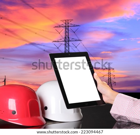 safety helmet on civil engineer working table against electical tower
