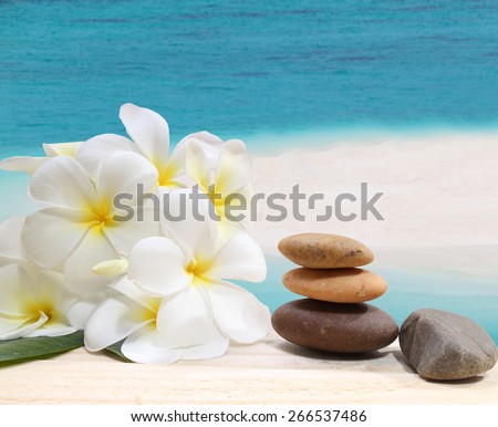 Zen spa concept background - Zen massage stones with frangipani plumeria flower