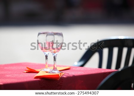 Close-up picture of preparing a glass  without water on the wooden table in cafe with copy place
