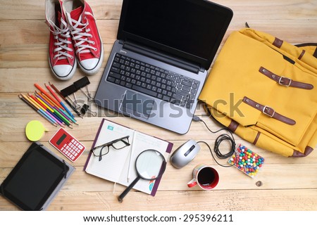 overhead of office table or student table  with notebook, computer keyboard and mouse, tablet pc and smartphone. copy space
