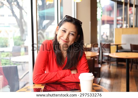 woman relaxing at home or cafe  with cup of coffee