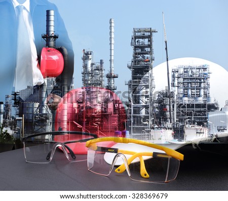 Double exposure of engineering man standing with red safety helmet against oil refinery in petrochemical industry