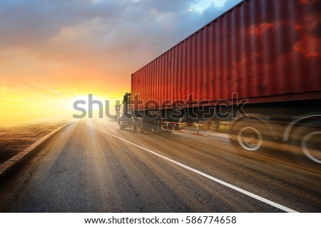 Generic big trucks speeding on the highway at sunset - Transport industry concept , big truck containers