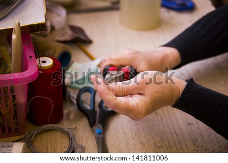 Woman working with pliers and other tools