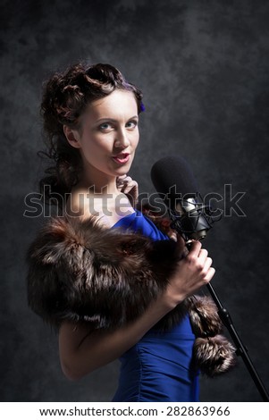 beautiful woman with microphone in dusk