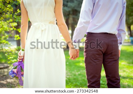 Young beautiful couple with wedding bouquet. Purple wedding.Just married.