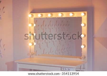 Woman\'s makeup place with mirror and bulbs