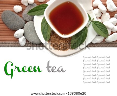 cup of green tea with text in white rocks and bamboo flooring