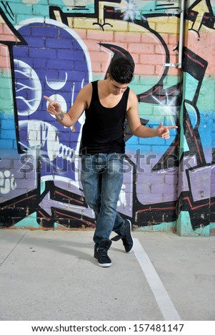 break-dance dancer on a city street posing with a dance move