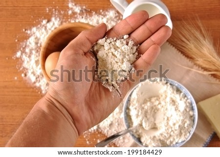 hand picking eggs and flour for cooking