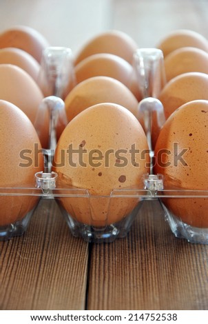eggs tucked in its box on a wooden table