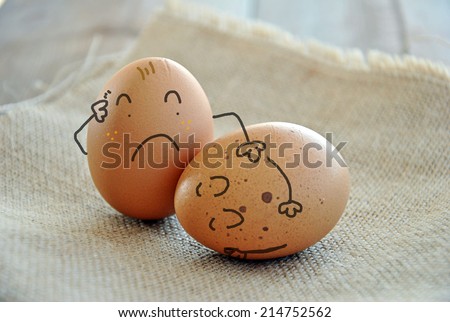 caricatures of eggs on wooden table and burlap