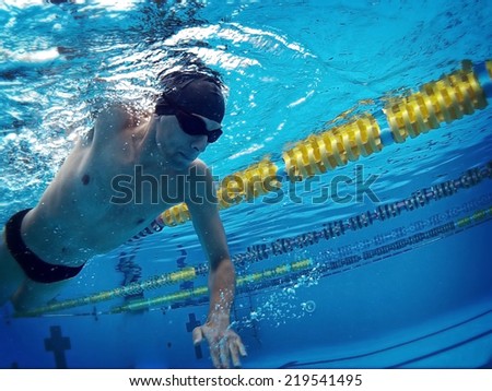 young swimmer in pool swimming